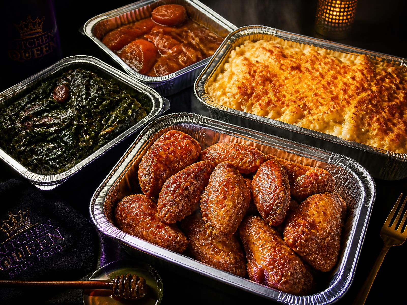 Trays of fried chicken wings, mac and cheese, candied yams and collard greens